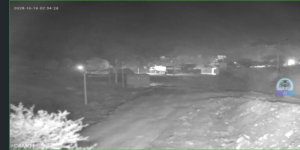 Live night view from an AI camera at a remote crusher and mining site, with the camera's AI badge